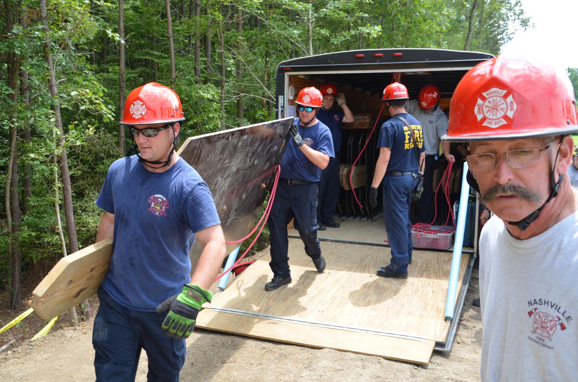 Group of Fire fighters unloading a trailer 